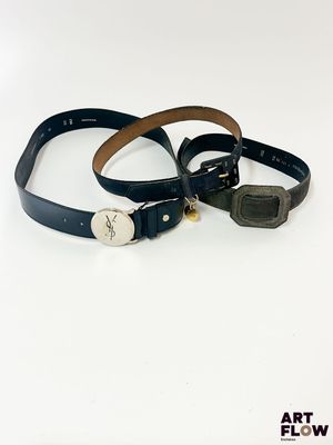 deux ceintures en cuir noir avec une boucle métallique sur fond blanc