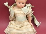 a small doll sitting on a red surface