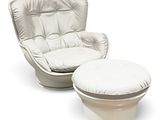 a white chair and ottoman sitting next to each other
