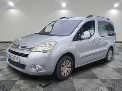 the silver van is parked on a checkered floor in the garage