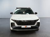 the front end of a white suv parked in a showroom