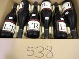 six bottles of wine are in a cardboard box with a price tag
