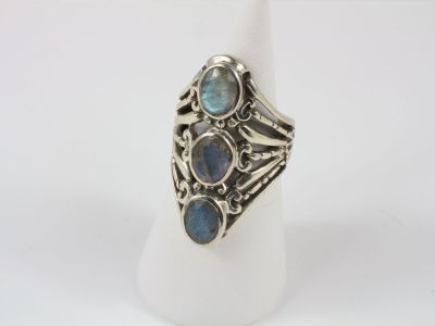 a close up of a silver ring with blue stones on it