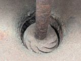 an image of a rusted metal pipe with a hole in it