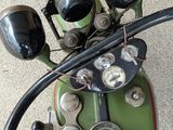 a close up of a green motorcycle with a black handlebar