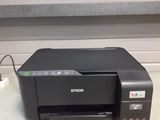 a black printer sitting on top of a counter next to a wall