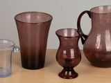 three glass vases sitting on a table next to each other