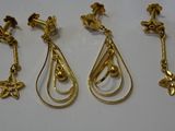 three pairs of gold earrings and a pair of earrings