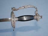 a silver sword with a black handle on a blue background