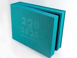 a blue book with a clock on it on a white surface