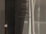 a close up of a clock on a glass wall