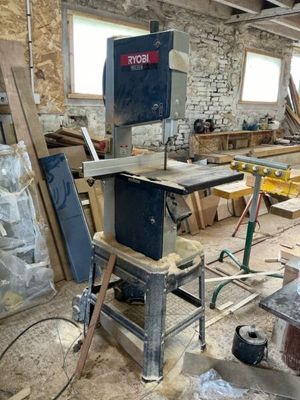 an image of a workshop with a table sawing machine