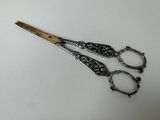 a pair of scissors sitting on a white surface