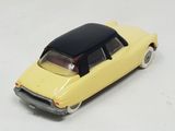 a yellow toy car with a black top on a white surface