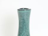 a green vase that is sitting on a table