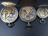three different types of pocket watches are shown on a black surface