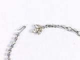 a necklace and earring set on a white surface