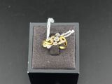 a close up of a ring in a black box on a table