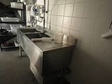a kitchen with a sink and a stove in it