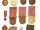 a group of medals and medals on display on a white surface