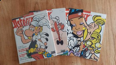 three comics are sitting on a wooden table next to a cup of coffee
