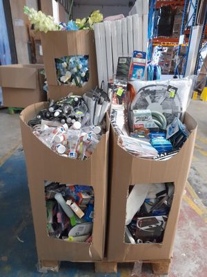 two cardboard boxes filled with assorted items in a warehouse
