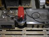 a blender sitting on top of a pallet in a warehouse