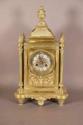 a gold clock that is sitting on a table