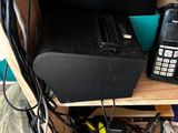 a phone and a printer sitting on a shelf in a room