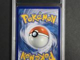 a close up of a pokemon card on a black surface