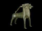 bronze figurine of a dog on a black background