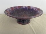 a purple bowl sitting on top of a table
