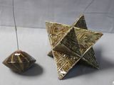 two pieces of art that are sitting on a table
