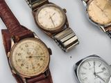 a lot of watches that are sitting on a table