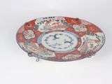 a red and blue plate with a bird on it