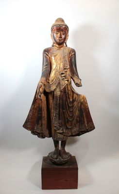 an image of a statue of a person standing on a wooden base