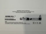 the back of a white laptop with a black and white sticker on it
