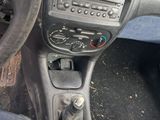 a dashboard of a car with a steering wheel and a control panel