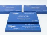four blue business cards sitting on top of each other on a table