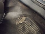a hole in the floor of a car that is dirty