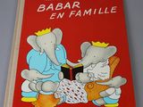 a red book with a picture of an elephant and an elephant reading a book