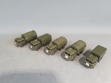 six toy army vehicles are lined up in a row on a white surface