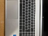 a laptop computer sitting on top of a desk next to a mouse