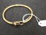 an image of a gold bracelet with a lion head on it