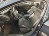 the interior of a car with the door open and the driver ' s seat up