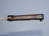 an old gun with a wooden handle is shown against a blue background