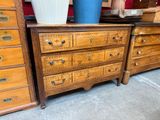 many drawers and a vase on a table in a room