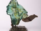 statue of a man holding a leaf on a base on a white background