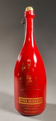 an image of a red bottle with a gold cap on it