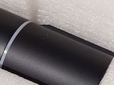 a close up of a black tube on a white surface